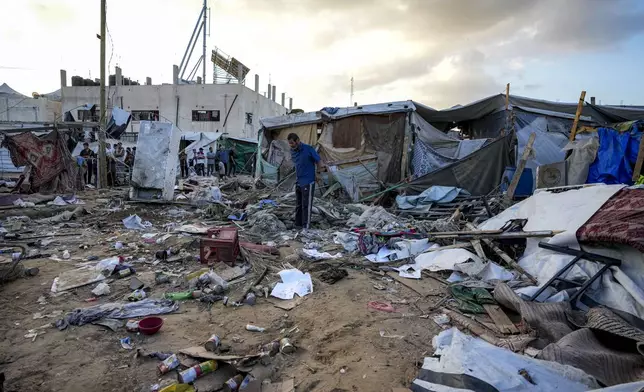 Palestinians inspect the damage at a tent area in the courtyard of Al Aqsa Martyrs hospital, hit by an Israeli bombardment on Deir al-Balah, central Gaza Strip, Thursday, Sept. 5, 2024. (AP Photo/Abdel Kareem Hana)