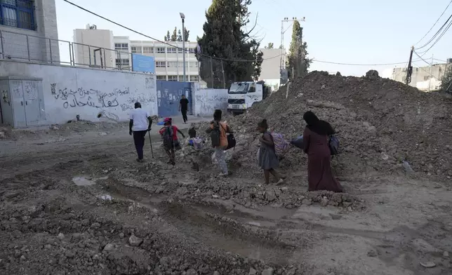 Palestinian refugees flee the West Bank refugee camp of Tulkarem, during an Israeli army operation in Tulkarem, Thursday, Sept. 12, 2024. (AP Photo/Nasser Nasser)