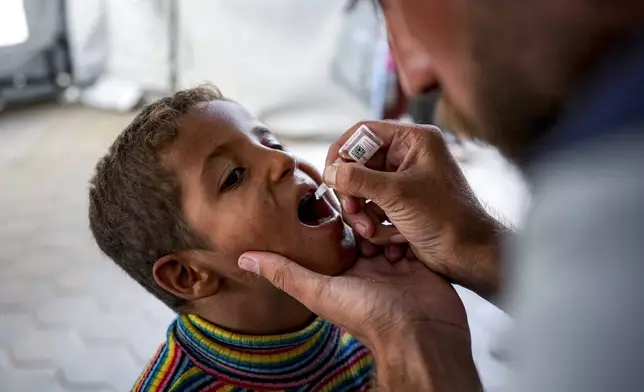 A health worker administers a polio vaccine to a child at a hospital in Deir al-Balah, central Gaza Strip, Sunday, Sept. 1, 2024. (AP Photo/Abdel Kareem Hana)