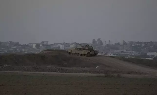 An Israeli tank overlooks the Gaza Strip, as seen from southern Israel, Wednesday, Sept. 11, 2024. (AP Photo/Tsafrir Abayov)