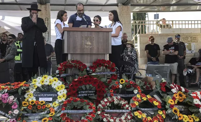 Jonathan Polin and Rachel Goldberg, parents, and sisters Orly and Leebie of killed US-Israeli hostage Hersh Goldberg-Polin whose body was recovered with five other hostages in Gaza, speak during the funeral in Jerusalem, Monday, Sept. 2, 2024. (Gil Cohen-Magen/Pool via AP)