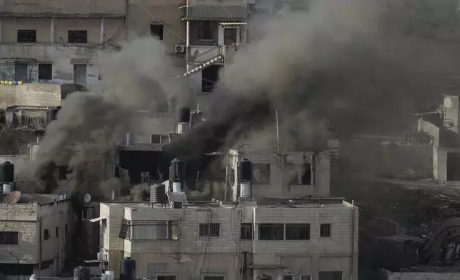 Houses are engulfed in fire as the Israeli army raided the northern West Bank town of Qabatiya on Thursday, Sept. 19, 2024. (AP Photo/Majdi Mohammed)