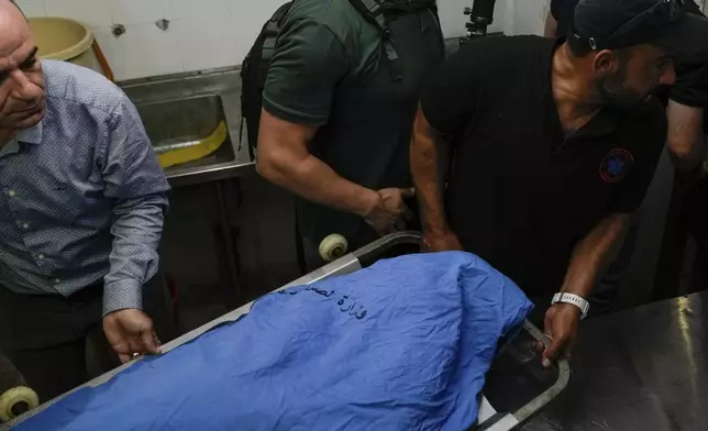 Palestinians carry the body of Turkish-American Aysenur Ezgi Eygi at the hospital morgue in Nablus, West Bank, Saturday, Sept. 7, 2024. Ezgi Eygi, 26, died after being shot in the head on Friday, Palestinian doctors said. Witnesses to the shooting said the was fatally shot by Israeli forces in a moment of calm after clashes between Palestinians and Israeli forces in the northern West Bank. (AP Photo/Majdi Mohammed)