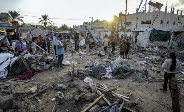 Palestinians inspect the damage at a tent area in the courtyard of Al Aqsa Martyrs hospital, hit by an Israeli bombardment on Deir al-Balah, central Gaza Strip, Thursday, Sept. 5, 2024. (AP Photo/Abdel Kareem Hana)