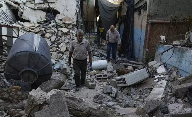 A Palestinian man inspects the damage to a building after Israeli forces raided the West Bank city of Jenin, Friday, Sept. 6, 2024. (AP Photo/Nasser Nasser)