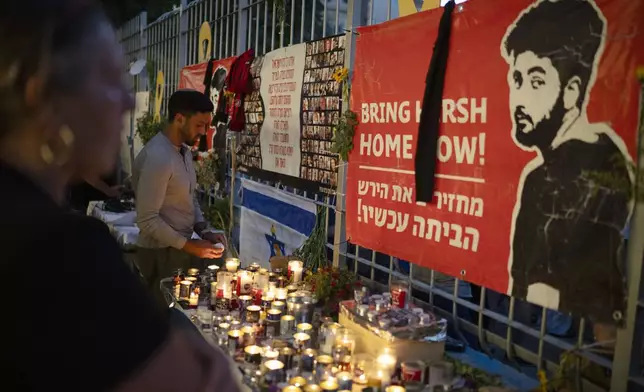 People light candles during a vigil in memory of slain hostage Hersh Goldberg-Polin in Jerusalem, Israel, Sunday, Sept. 1, 2024. (AP Photo/Leo Correa)