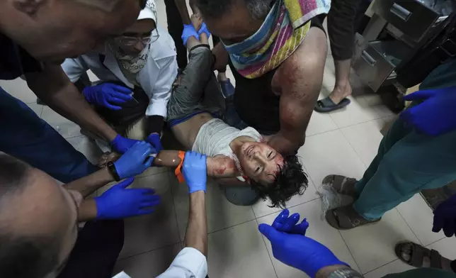 A Palestinian child wounded in the Israeli bombardment of the Gaza Strip is treated in a hospital in Deir al-Balah, Monday, Sept. 23, 2024. (AP Photo/Abdel Kareem Hana)