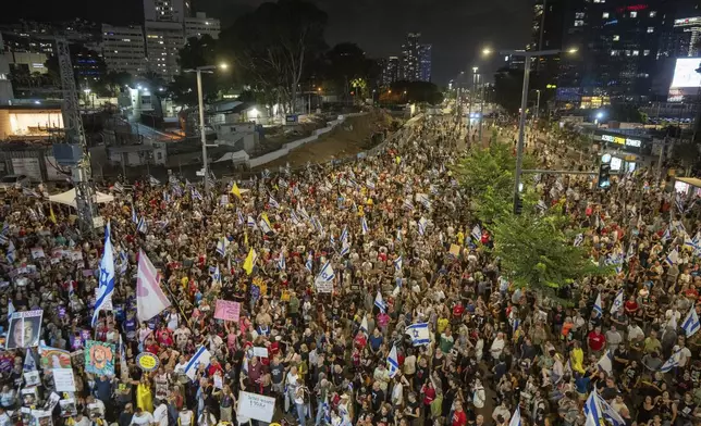 People protest against Prime Minister Benjamin Netanyahu's government and call for the release of hostages held in the Gaza Strip by the Hamas militant group, in Tel Aviv, Israel, Saturday, Aug. 31, 2024. (AP Photo/Ohad Zwigenberg)