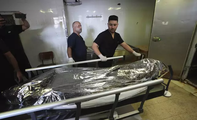 Palestinian paramedics move the body of Aysenur Ezgi Eygi, 26, who was fatally shot by Israeli soldiers while participating in an anti-settlement protest in the West Bank, at the morgue of the Rafedia hospital, in the West Bank city of Nablus Friday, Sept. 6, 2024. (AP Photo)