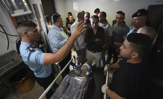 Palestinians gather around the body of Aysenur Ezgi Eygi, 26, who was fatally shot by Israeli soldiers while participating in an anti-settlement protest in the West Bank, at the morgue of the Rafedia hospital, in the West Bank city of Nablus Friday, Sept. 6, 2024. (AP Photo)