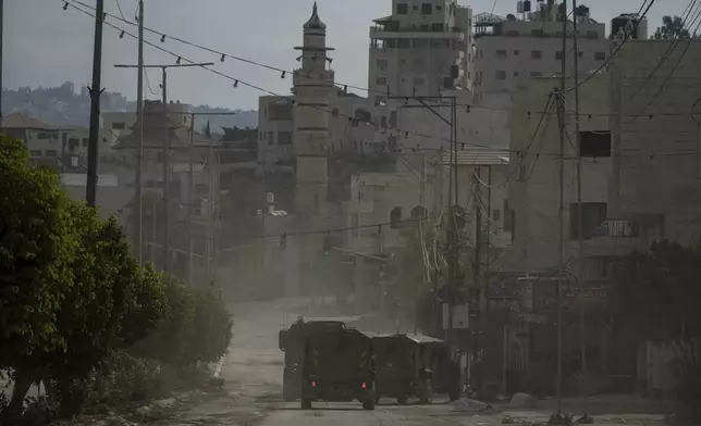 A convoy of Israeli military armored vehicles is seen during an army raid in Tulkarem, West Bank, on Tuesday, Sept. 3, 2024. (AP Photo/Majdi Mohammed)