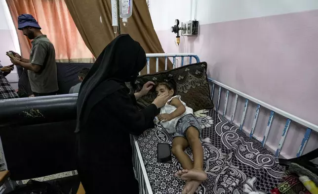 A Palestinian child waits to receive a polio vaccination at a hospital in Khan Younis, Saturday, Aug. 31, 2024. (AP Photo/Abdel Kareem Hana)