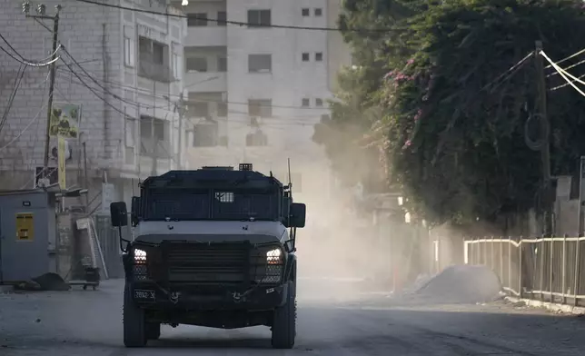 An Israeli armoured vehicle moves on a street during a military operation in the West Bank city of Jenin, Wednesday, Sept. 25, 2024.(AP Photo/Majdi Mohammed)