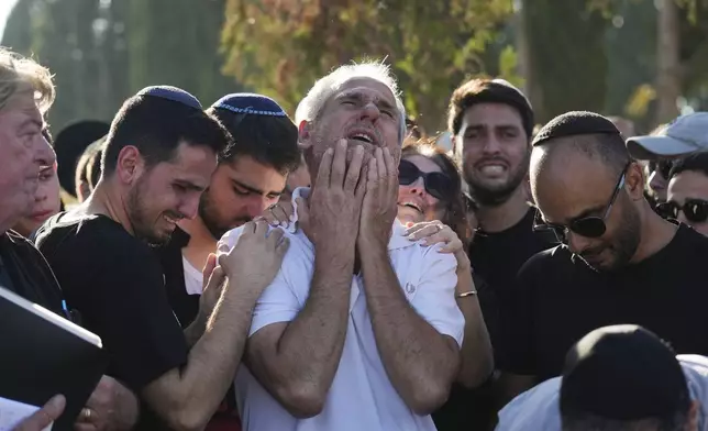 Yigal Sarusi, center, mourns during the funeral of his son, slain hostage Almog Sarusi, who was killed in Hamas captivity in the Gaza Strip, at a cemetery in Ra'anana, Israel, Sunday, Sept. 1, 2024. (AP Photo/Ariel Schalit)