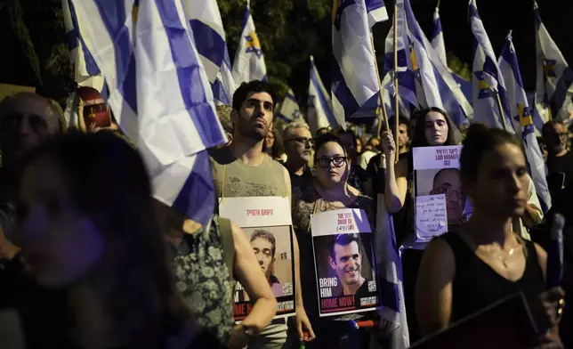 People attend a rally demanding a cease-fire deal and the immediate release of hostages held by Hamas in the Gaza Strip after the deaths of six hostages in the Palestinian territory , in Jerusalem, on Monday, Sept. 2, 2024. (AP Photo/Leo Correa)