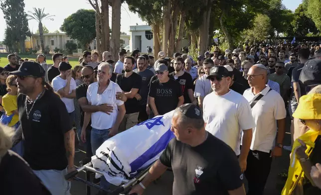 Relatives and friends attend the funeral of slain hostage Almog Sarusi, who was killed in Hamas captivity in the Gaza Strip, at a cemetery in Ra'anana, Israel, Sunday, Sept. 1, 2024. (AP Photo/Ariel Schalit)