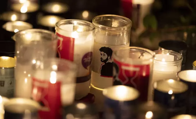 A candle with an image depicting the slain hostage Hersh Goldberg-Polin is seen on a table during a vigil in his memory in Jerusalem, Israel, Sunday, Sept. 1, 2024. (AP Photo/Leo Correa)