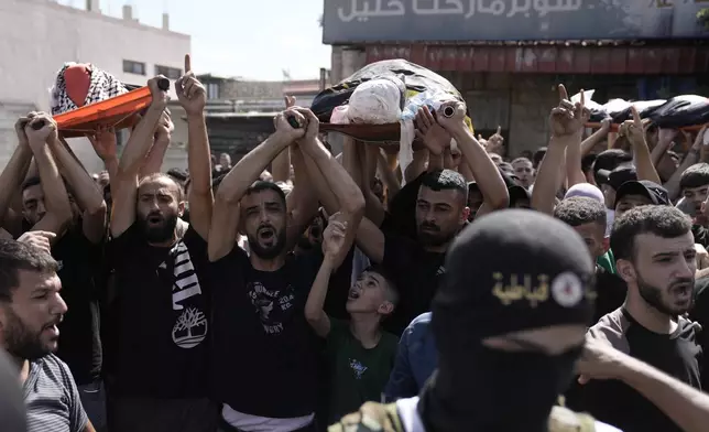 Mourners march during the funeral for three Palestinian militants killed in an Israeli military operation in the West Bank town of Qabatiya, Friday, Sept. 20, 2024. (AP Photo/Majdi Mohammed)