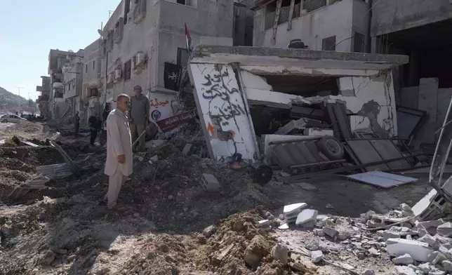 People inspect the destruction following an Israeli forces raid in Tulkarem, West Bank, on Wednesday, Sept. 11, 2024. (AP Photo/Majdi Mohammed)