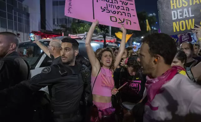 People protest against Prime Minister Benjamin Netanyahu's government and call for the release of hostages held in the Gaza Strip by the Hamas militant group, in Tel Aviv, Israel, Saturday, Aug. 31, 2024. (AP Photo/Ohad Zwigenberg)