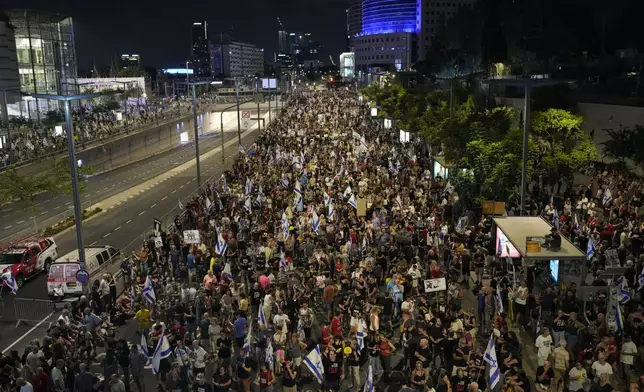 People protest against Israeli Prime Minister Benjamin Netanyahu's government and call for the release of hostages held in the Gaza Strip by the Hamas militant group in Tel Aviv, Israel, Saturday, Aug. 31, 2024. (AP Photo/Ohad Zwigenberg)