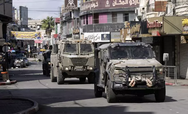 Israeli army jeeps move into the West Bank city of Nablus during a raid, Sunday, Sept. 22, 2024,(AP Photo/Majdi Mohammed).