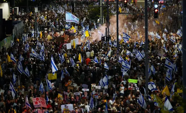 People protest against Prime Minister Benjamin Netanyahu's government and call for the release of hostages held in the Gaza Strip by the Hamas militant group, in Tel Aviv, Israel, Saturday, Sept. 7, 2024. (AP Photo/Ariel Schalit)