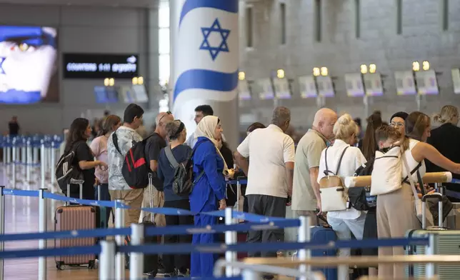 Travelers line up at Ben Gurion International Airport near Tel Aviv, Israel, Monday Sept. 2, 2024. Outgoing flights at the airport were halted for two hours on Monday morning as part of a general strike launched in response to the deaths of hostages held in Gaza. (AP Photo/Ohad Zwigenberg)