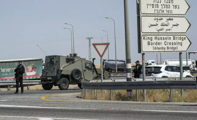 Israeli police stand guard near the site of a deadly shooting attack where Israeli officials say three people were shot and killed at the Allenby Bridge Crossing between the West Bank and Jordan, Sunday, Sept. 8, 2024. (AP Photo/Mahmoud Illean)