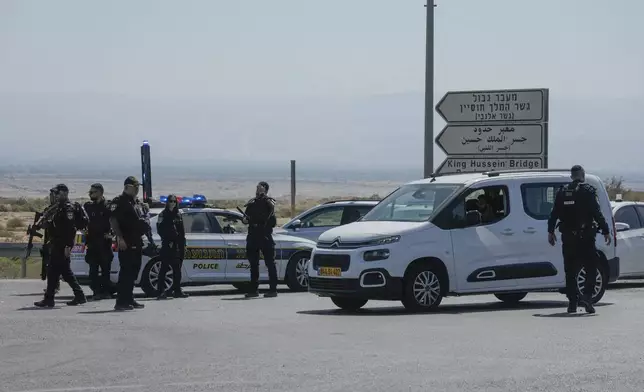 Israeli police stand guard near the site of a deadly shooting attack where Israeli officials say three people were shot and killed at the Allenby Bridge Crossing between the West Bank and Jordan, Sunday, Sept. 8, 2024. (AP Photo/Mahmoud Illean)