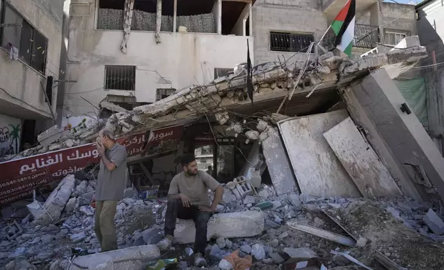 People inspect the destruction following an Israeli forces raid in Tulkarem, West Bank, on Wednesday, Sept. 11, 2024. (AP Photo/Majdi Mohammed)