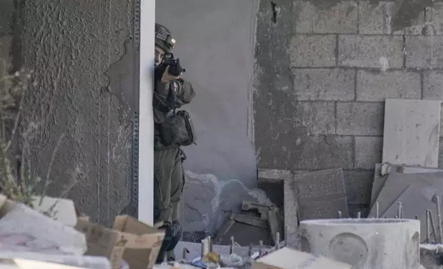 An Israeli soldier aims her rifle during an army raid in Tubas, West Bank, on Wednesday, Sept. 11, 2024. (AP Photo/Majdi Mohammed)