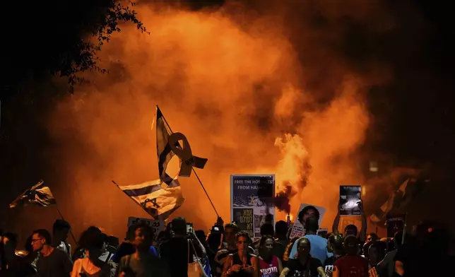 People attend a rally demanding a cease-fire deal and the immediate release of hostages held by Hamas in the Gaza Strip after the deaths of six hostages in the Palestinian territory in Tel Aviv, Israel, on Monday, Sept. 2, 2024. (AP Photo/Ariel Schalit)