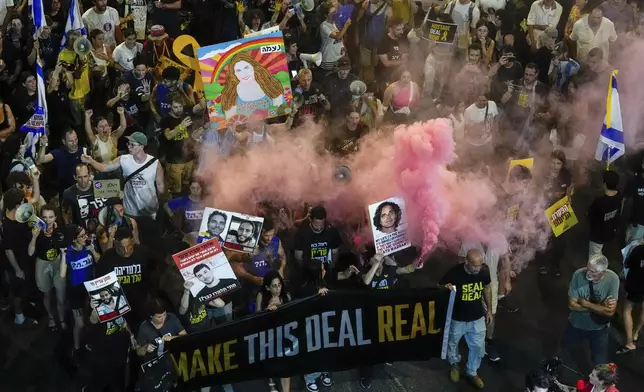 In this aerial image, people attend a rally demanding a cease-fire deal and the immediate release of hostages held by Hamas in the Gaza Strip in Tel Aviv, Israel on Wednesday, Sept. 4, 2024. (AP Photo/Ariel Schalit)