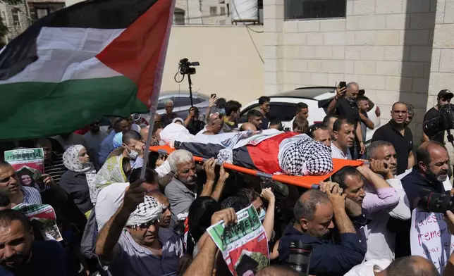 Mourners carry the body of Aysenur Ezgi Eygi, 26, who was fatally shot by Israeli soldiers while participating in an anti-settlement protest in the West Bank, during her funeral procession in the West Bank city of Nablus, Monday, Sept. 9, 2024. (AP Photo/Nasser Nasser)