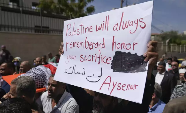 Mourners carry the body of Aysenur Ezgi Eygi, 26, who was fatally shot by Israeli soldiers while participating in an anti-settlement protest in the West Bank, during her funeral procession in the West Bank city of Nablus, Monday, Sept. 9, 2024. (AP Photo/Nasser Nasser)