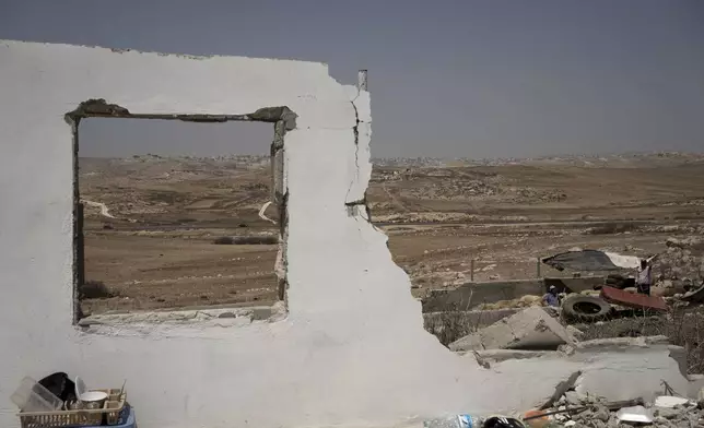 The ruins of a home in the West Bank village of Khirbet Zanuta, destroyed when residents were driven out by Israeli settlers, Tuesday, Aug. 27, 2024. Ten months after settlers threatened to kill them if they didn't leave their village, some Palestinian residents are finally home, under a rare court order. (AP Photo/Maya Alleruzzo)