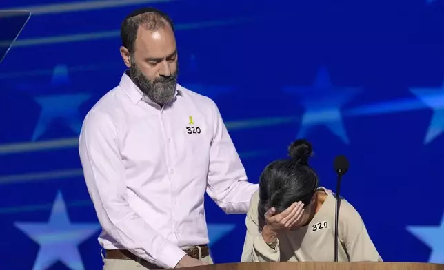 FILE - Jon Polin, left, and Rachel Goldberg, parents of Hersh Goldberg-Polin, speak on stage during the Democratic National Convention Wednesday, Aug. 21, 2024, in Chicago. (AP Photo/J. Scott Applewhite, File)