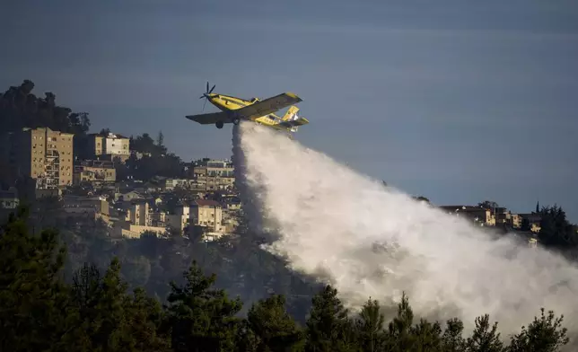 An Israeli firefighters plane uses a fire retardant to extinguish a fire after a rocket fired from Lebanon hit an open area near the city of Safed, northern Israel, on Saturday, Sept. 21, 2024. (AP Photo/Leo Correa)