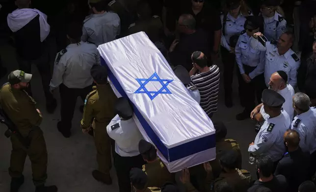 Israeli soldiers carry the flag-draped casket of reservist Major Nael Fwarsy, one of two soldiers killed by a Lebanese drone attack on northern Israel, during his funeral in Maghar, Israel, Friday, Sept 20, 2024. (AP Photo/Ohad Zwigenberg)