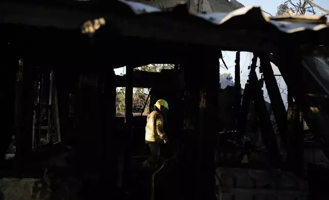 Israeli firefighters work at a house that was hit by a rocket fired from Lebanon, near the city of Safed, northern Israel, on Saturday, Sept. 21, 2024. (AP Photo//Leo Correa)