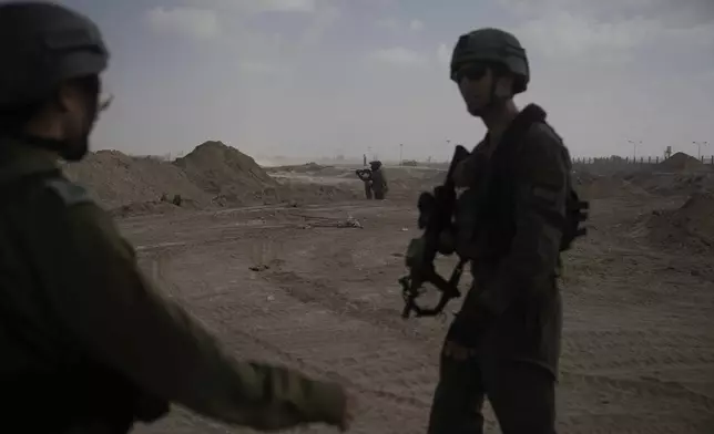 Israeli soldiers take up positions next to the Philadelphi Corridor along the border with Egypt, in the Gaza Strip on Friday, Sept. 13, 2024. (AP Photo/Leo Correa)