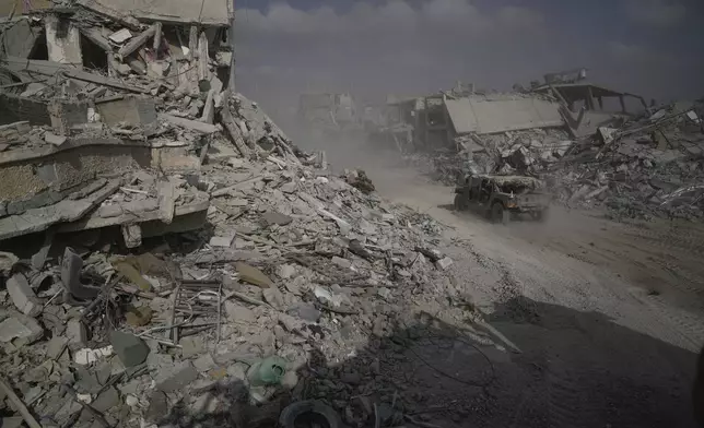 Israeli soldiers drive next to destroyed buildings following Israeli strikes during a ground operation in the Gaza Strip on Friday, Sept. 13, 2024. (AP Photo/Leo Correa)