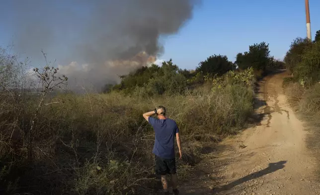 Smoke rises from a fire in central Israel after the Israeli army said a missile fired from Yemen landed in an open area on Sunday, Sept. 15, 2024. (AP Photo/Ohad Zwigenberg)