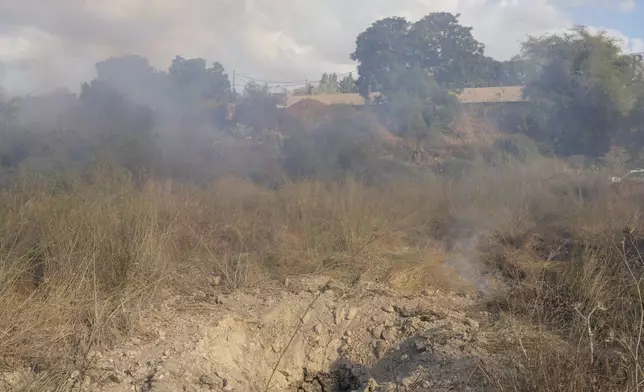 A crater is seen after the military fired interceptors at what the Israeli army says is a missile launched from Yemen that landed in central Israel on Sunday, Sept. 15, 2024. (AP Photo/Ohad Zwigenberg)