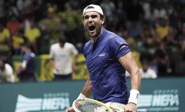 Matteo Berrettini, of Italy, celebrates defeating Joao Fonseca, of Brazil, in a Davis Cup tennis match at Unipol Arena in Casalecchio di Reno, near Bologna, Italy, Wednesday, Sept. 11, 2024. (Michele Nucci/LaPresse via AP)