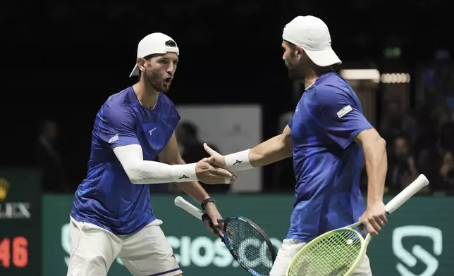 Italy's Andrea Vavassori and Simone Bolelli celebrate during a Davis Cup tennis match against Brazil's Rafael Matos and Marcelo Melo at Unipol Arena in Casalecchio di Reno, near Bologna, Italy, Wednesday, Sept. 11, 2024. (Massimo Paolonei/LaPresse via AP)