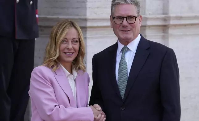 Italian Premier Giorgia Meloni, left, welcomes U.K. Prime Minister Keir Starmer as they meet at Villa Panphilj in Rome, Monday, Sept. 16, 2024. U.K. Prime Minister Keir Starmer is meeting Italian Premier Giorgia Meloni in Rome on Monday, as the two very different politicians, from left and right, seek common cause to curb migrants reaching their shores by boat. The visit comes after at least eight seaborne migrants died off the French coast over the weekend. (AP Photo Andrew Medichini)