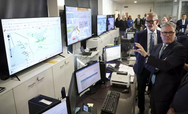 British Prime Minister Keir Starmer, right, visits Italy’s national immigration crime coordination center, on the occasion of his visit to Rome, Monday, Sept. 16, 2024. (Phil Noble/Pool Photo via AP)