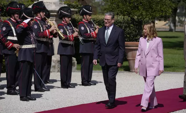 Italian Premier Giorgia Meloni, right, welcomes U.K. Prime Minister Keir Starmer as they meet at Villa Panphilj in Rome, Monday, Sept. 16, 2024. U.K. Prime Minister Keir Starmer is meeting Italian Premier Giorgia Meloni in Rome on Monday, as the two very different politicians, from left and right, seek common cause to curb migrants reaching their shores by boat. The visit comes after at least eight seaborne migrants died off the French coast over the weekend. (AP Photo Andrew Medichini)